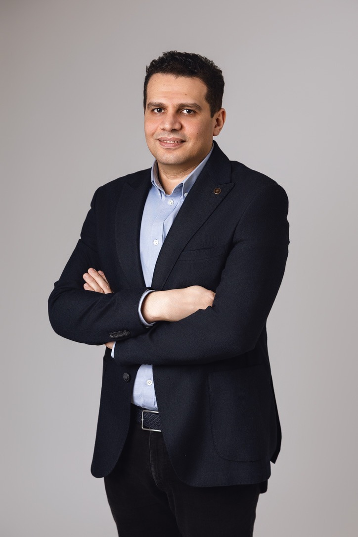 Mohamed Talaye, standing, light background